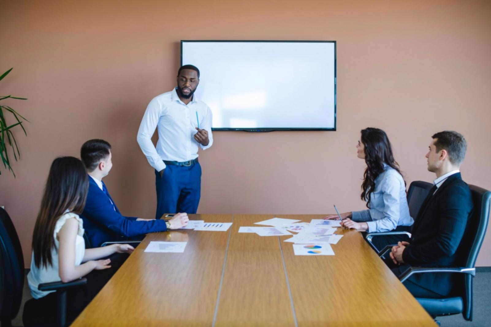 Modern trading workspace with multiple monitors displaying market data and charts