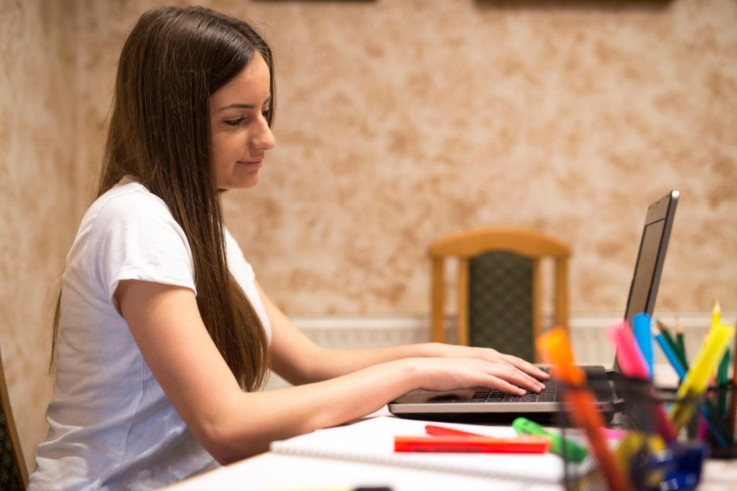 Student reviewing trading charts and educational materials during a learning session